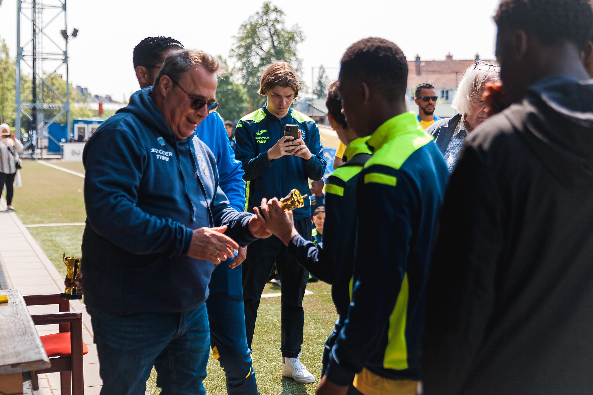 Michel Pradolini handing trophees to youth players during the Pirates Parade