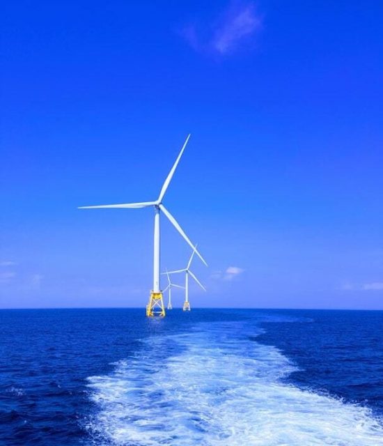 Offshore wind turbines at sea representing renewable energy support and maritime catering services for the wind industry.